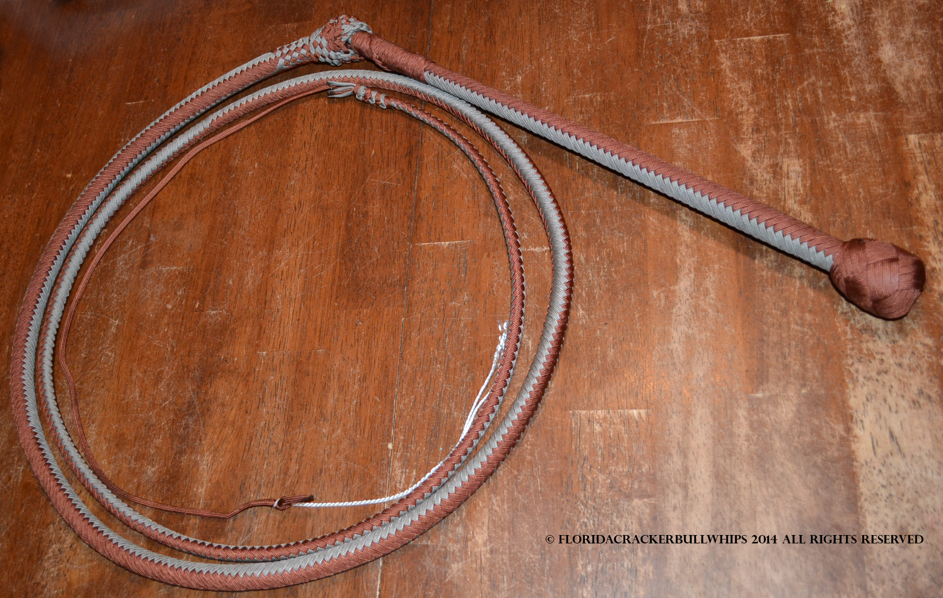 16 plait nylon stock whip in cow tale pattern colors chocolate brown and gray.